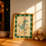 A framed children's art print featuring a green cartoon alligator roller skate, leaning against a wall in a sunlit nursery next to a stuffed bunny.