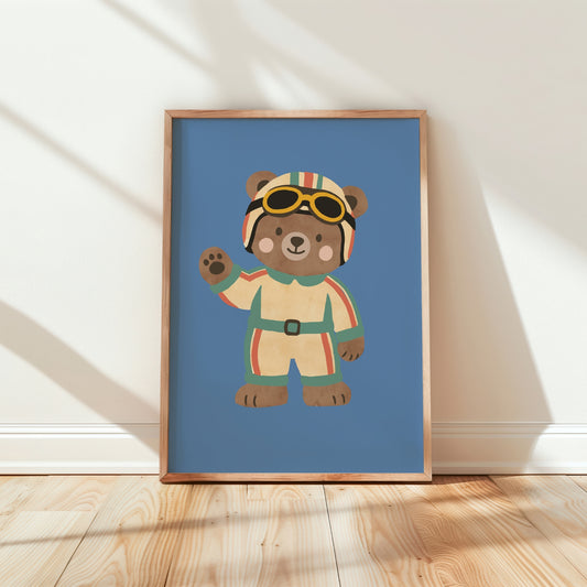 Racing bear kids print in oak frame — teddy in striped race suit, helmet and yellow goggles waving on blue background