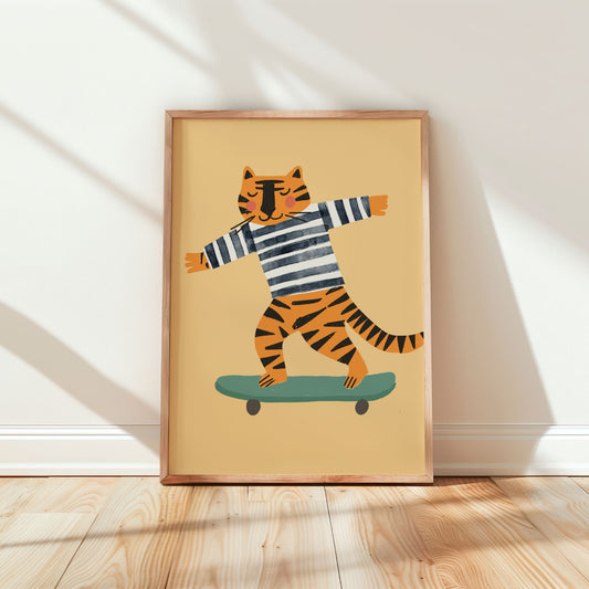 A framed art print featuring a cartoon tiger in a black and white striped shirt balancing on a green skateboard, leaning against a white wall on a light wood floor.