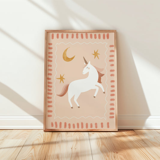 Hand-drawn white unicorn with gold horn under a crescent moon and stars on dusty pink – by Little Lemons Art