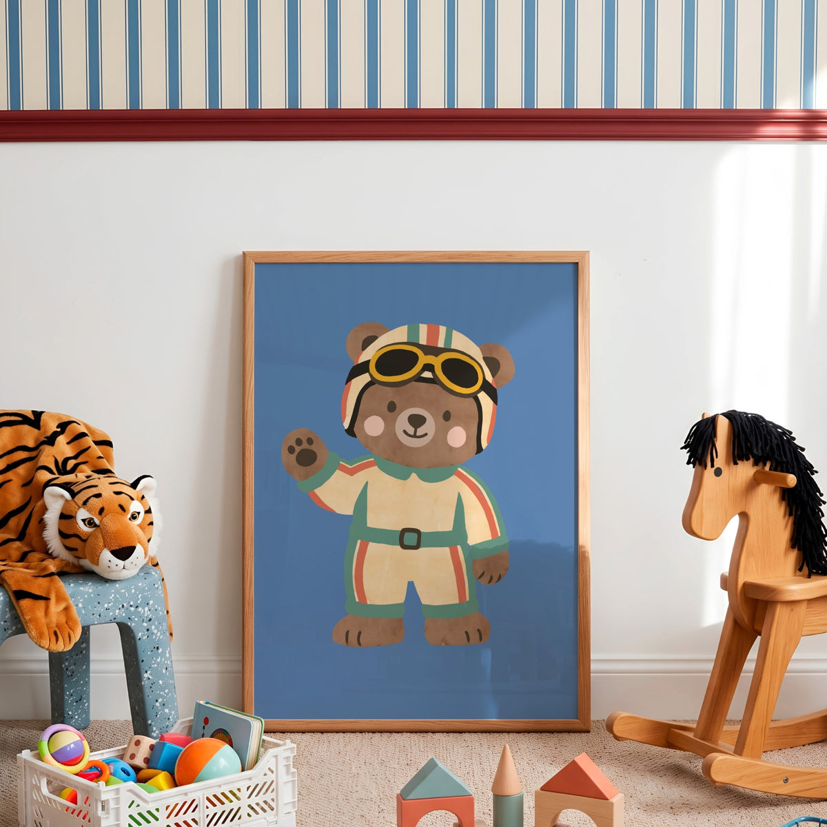Framed racing bear print leaning against playroom wall beside rocking horse, tiger plush and toy blocks
