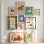 A gallery wall display of nine framed farm-themed art prints arranged on a white wall in a child-friendly nursery setting.