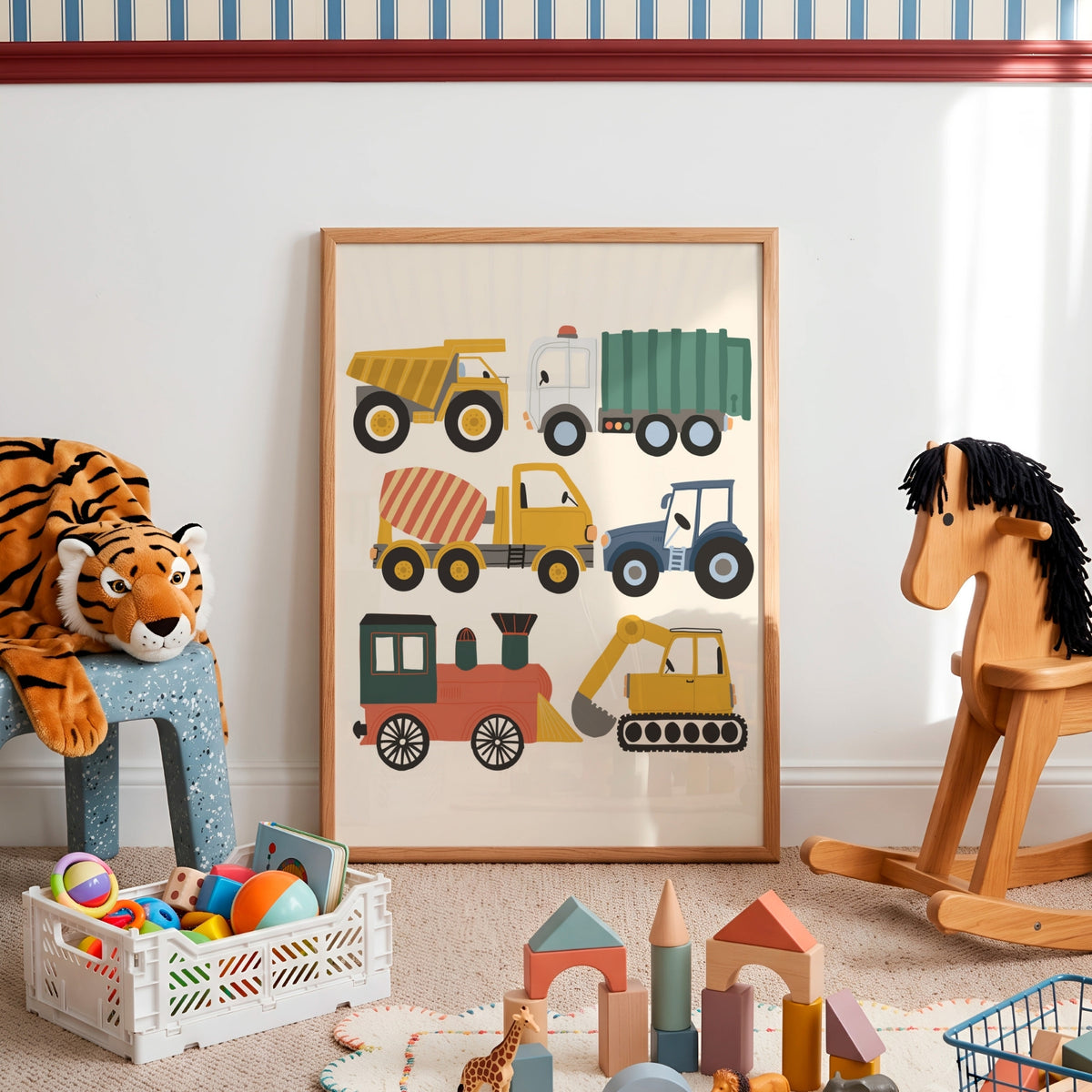 A framed children's wall art print featuring colorful construction vehicles, displayed in a styled nursery or playroom with toys, a rocking horse, and a stuffed tiger.