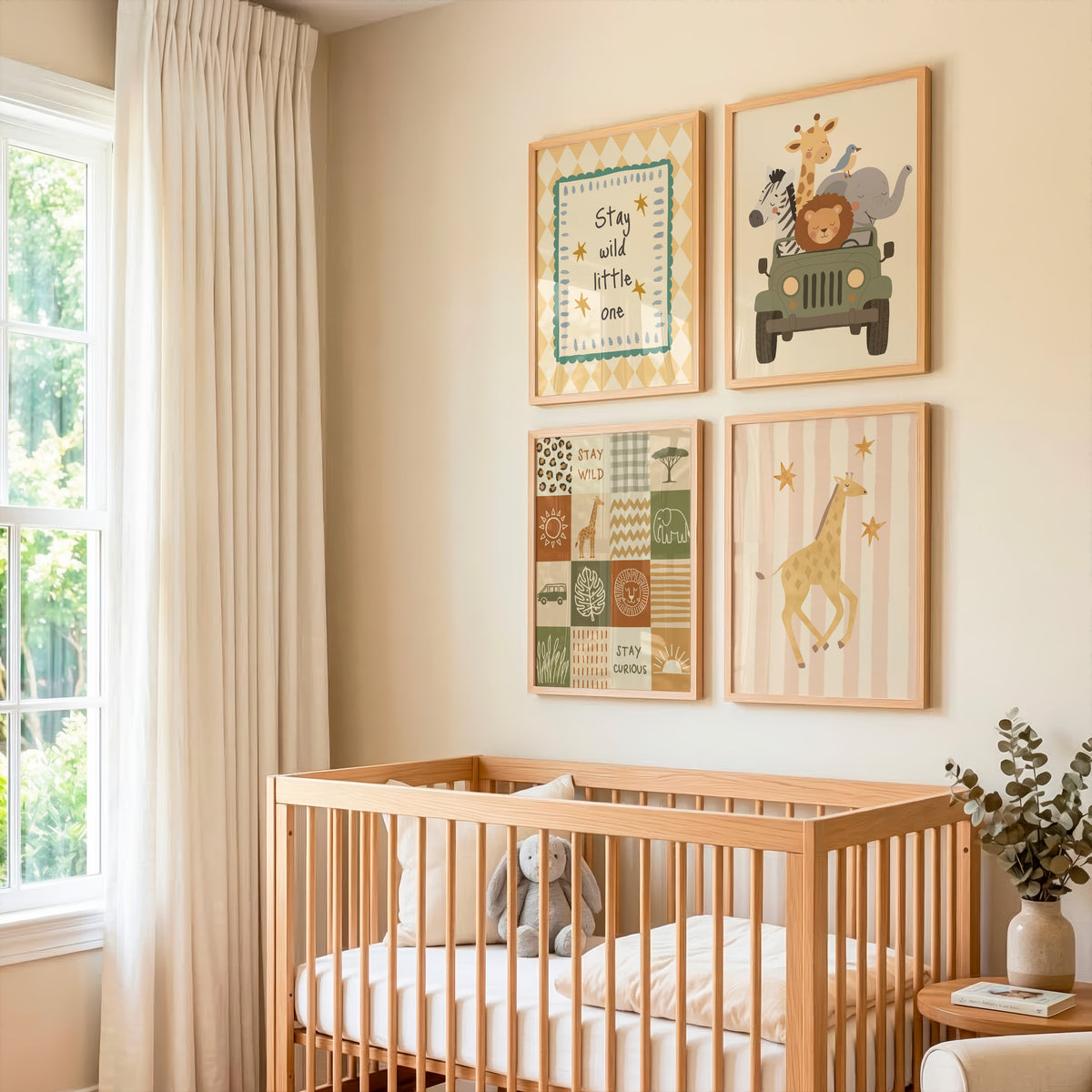 A styled nursery corner with a light wood crib, cream bedding, a gray plush toy, and four framed animal and text wall prints above the bed. The room has beige walls, a window with sheer curtains, and a small side table with a vase.
