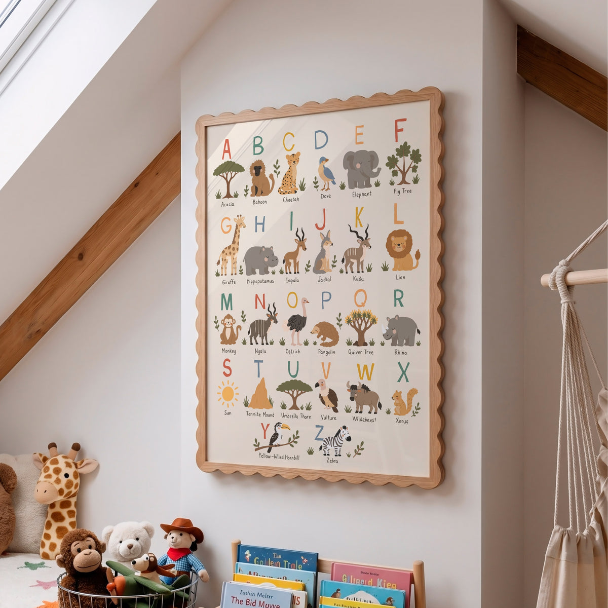 A framed children's alphabet wall poster with safari animals and letters, hanging on a white wall in a nursery or children's room. The wooden frame is scalloped, and the poster shows animals such as giraffe, elephant, lion, and zebra with their names.