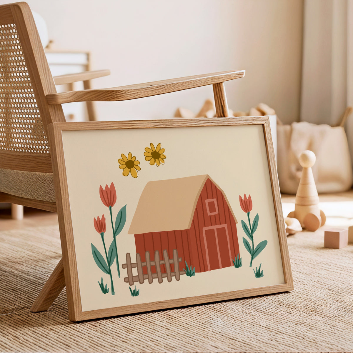A framed art print featuring a whimsical barn illustration with yellow sunflowers and red tulips, styled in a warm, rustic children's room next to a wooden chair.