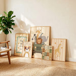 A set of six framed children's wall art prints with safari and animal themes, arranged leaning against a beige wall on a light wood floor next to a potted plant.
