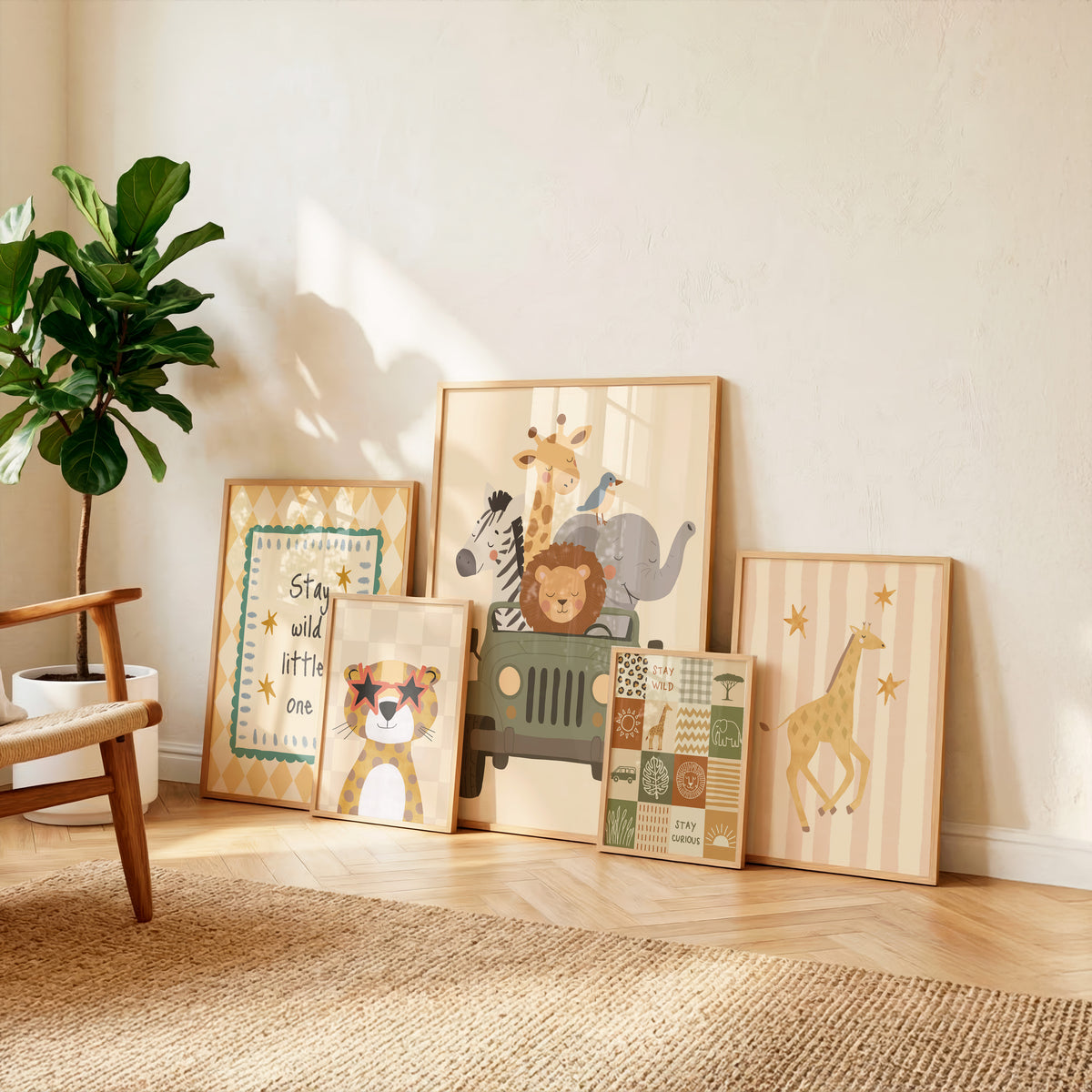 A set of six framed children's wall art prints with safari and animal themes, arranged leaning against a beige wall on a light wood floor next to a potted plant.