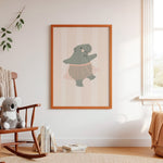 Framed Ballerina Hippo print styled in a nursery – hand-drawn ballerina hippo in a pink tutu on a candy-stripe background