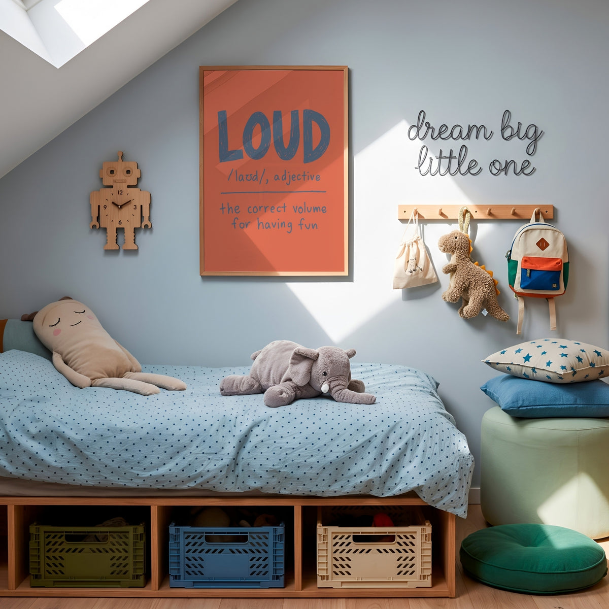 A styled children's bedroom corner with a low wooden bed, light blue bedding, plush toys, wall decor including a framed orange 'LOUD' print and 'dream big little one' sign, storage bins, and a stool.