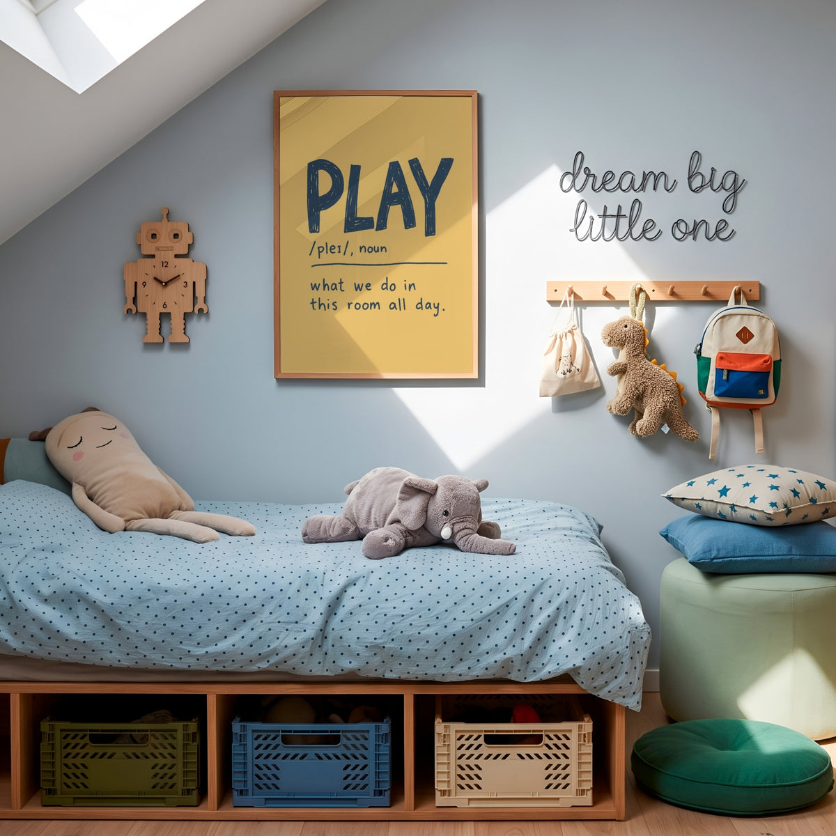 A styled children's bedroom corner with a wooden bed frame, light blue bedding, plush toys, wall decor including a framed 'PLAY' print and 'dream big little one' sign, storage bins, and a green pouf.