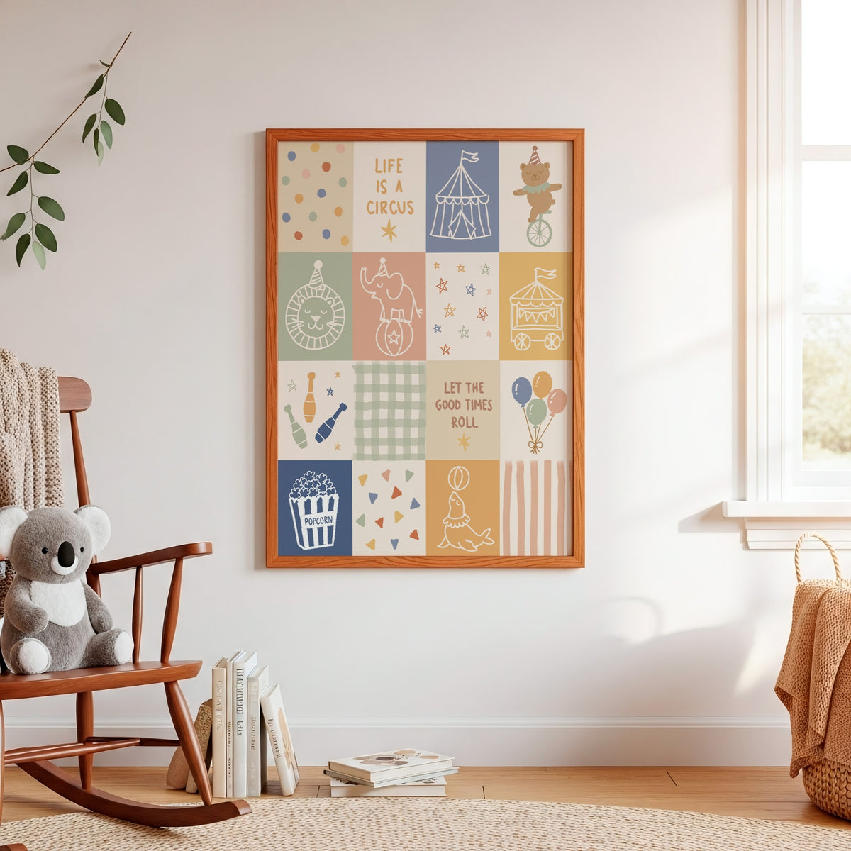 A framed nursery wall art print with a circus-themed patchwork design hangs on a white wall in a styled nursery room. The print features illustrations of a circus tent, elephant, carousel, popcorn machine, balloons, and the phrases 'LIFE IS A CIRCUS' and 'LET THE GOOD TIMES ROLL'.