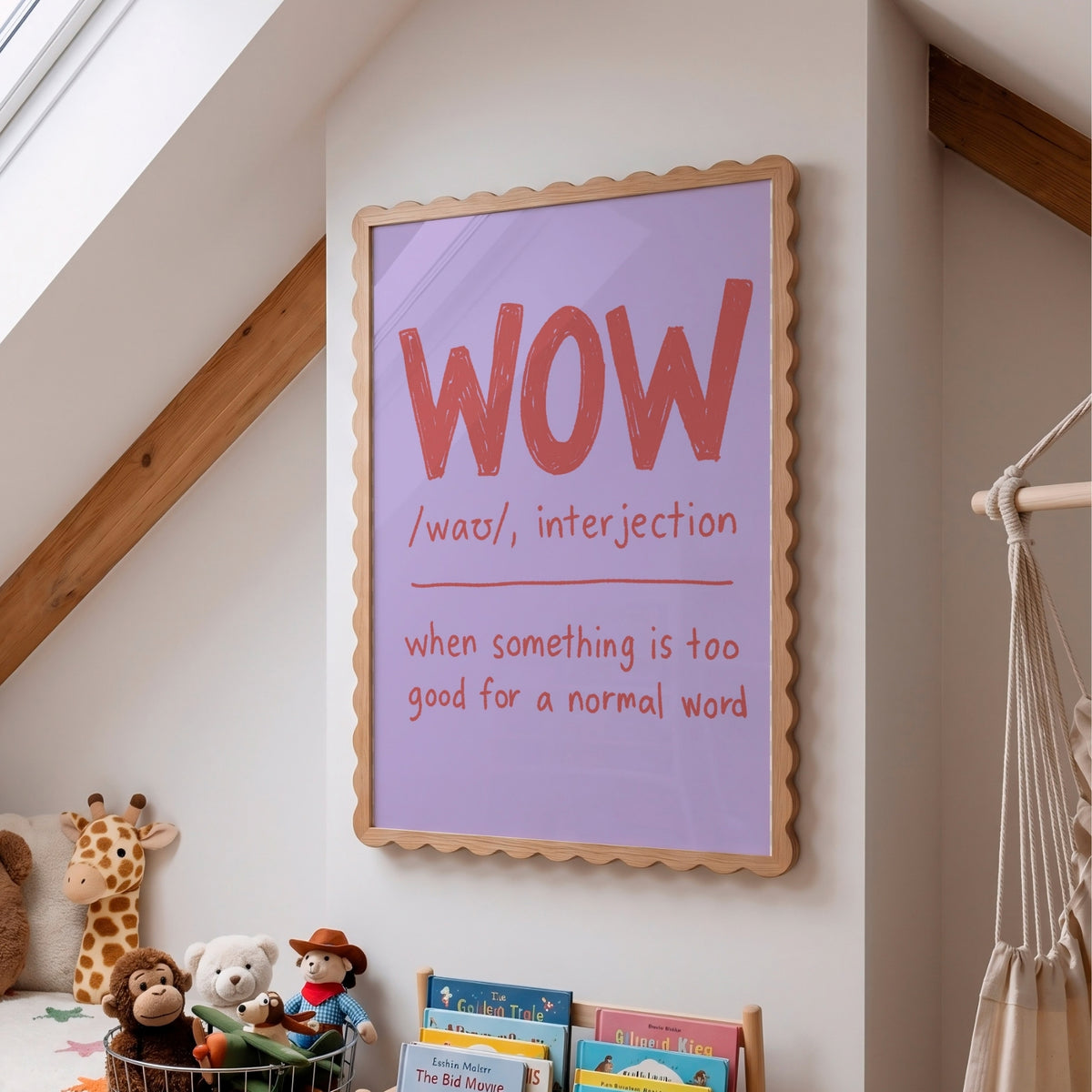 A framed educational wall art print featuring the word 'WOW' with phonetic spelling and a definition, styled in a child's attic bedroom next to a macrame hanger and toys.