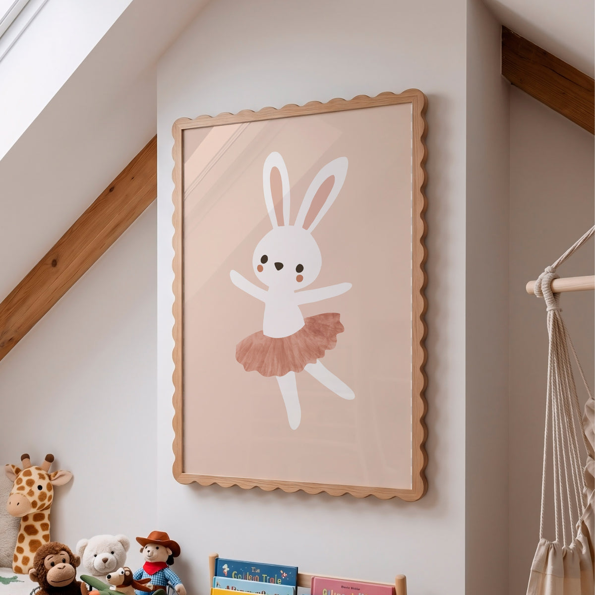 A framed children's wall art print featuring a white bunny in a pink tutu on a warm beige background, hanging on a white wall in a styled nursery with wooden beams, toys, and a macrame hanging visible below.