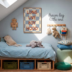 A styled children's bedroom corner with a single bed, blue bedding, plush toys, wall decor, and a framed poster reading 'LONG LIVE BOY HOOD' on a light blue wall.