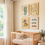 A styled nursery interior with a light wood crib against a beige wall, decorated with four framed art prints above it. The prints show a skateboard, the text 'OK LET'S PLAY' with black polka dots, a tiger on a skateboard, and three retro race cars.