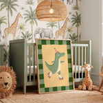 A framed nursery art print featuring a green cartoon crocodile roller skate, leaning against a sage green crib in a styled nursery room with safari wallpaper, a wicker pendant light, and toys.
