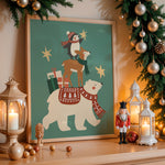 A framed Christmas art print featuring a polar bear, fox, and penguin with gifts and stars, styled on a wooden mantel with warm lanterns, ornaments, and a garland.