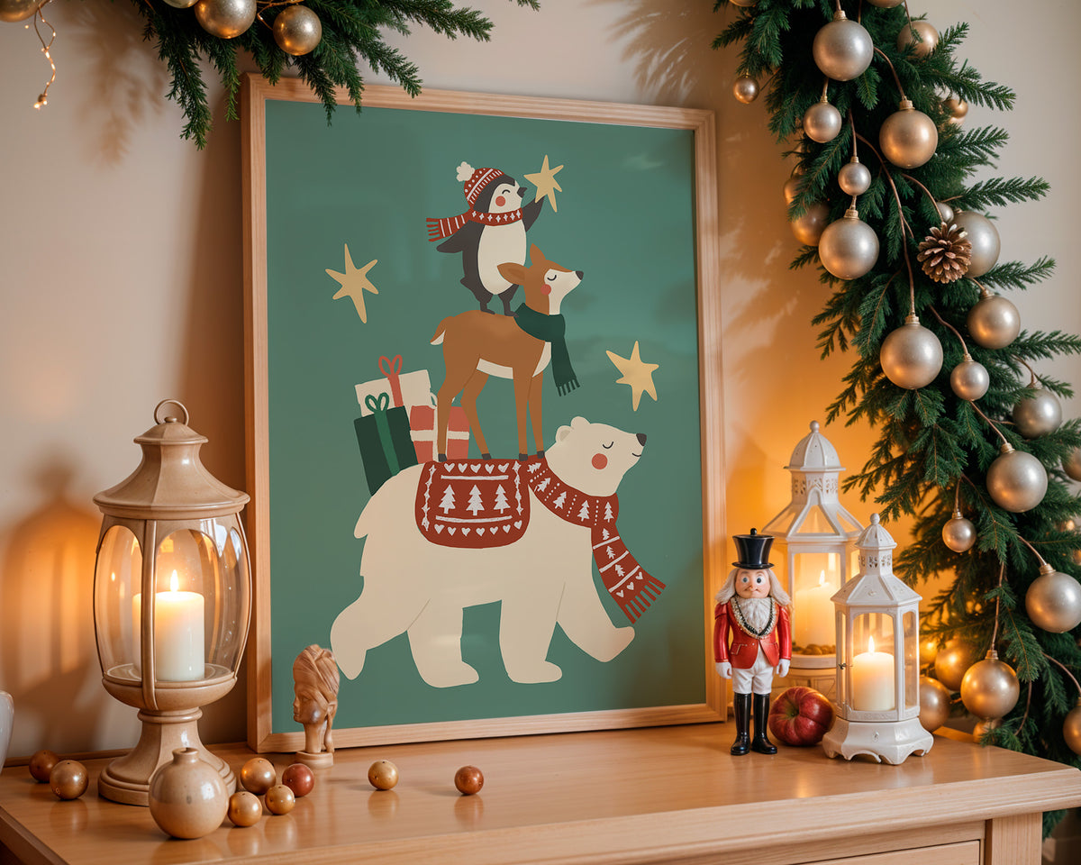 A framed Christmas art print featuring a polar bear, fox, and penguin with gifts and stars, styled on a wooden mantel with warm lanterns, ornaments, and a garland.
