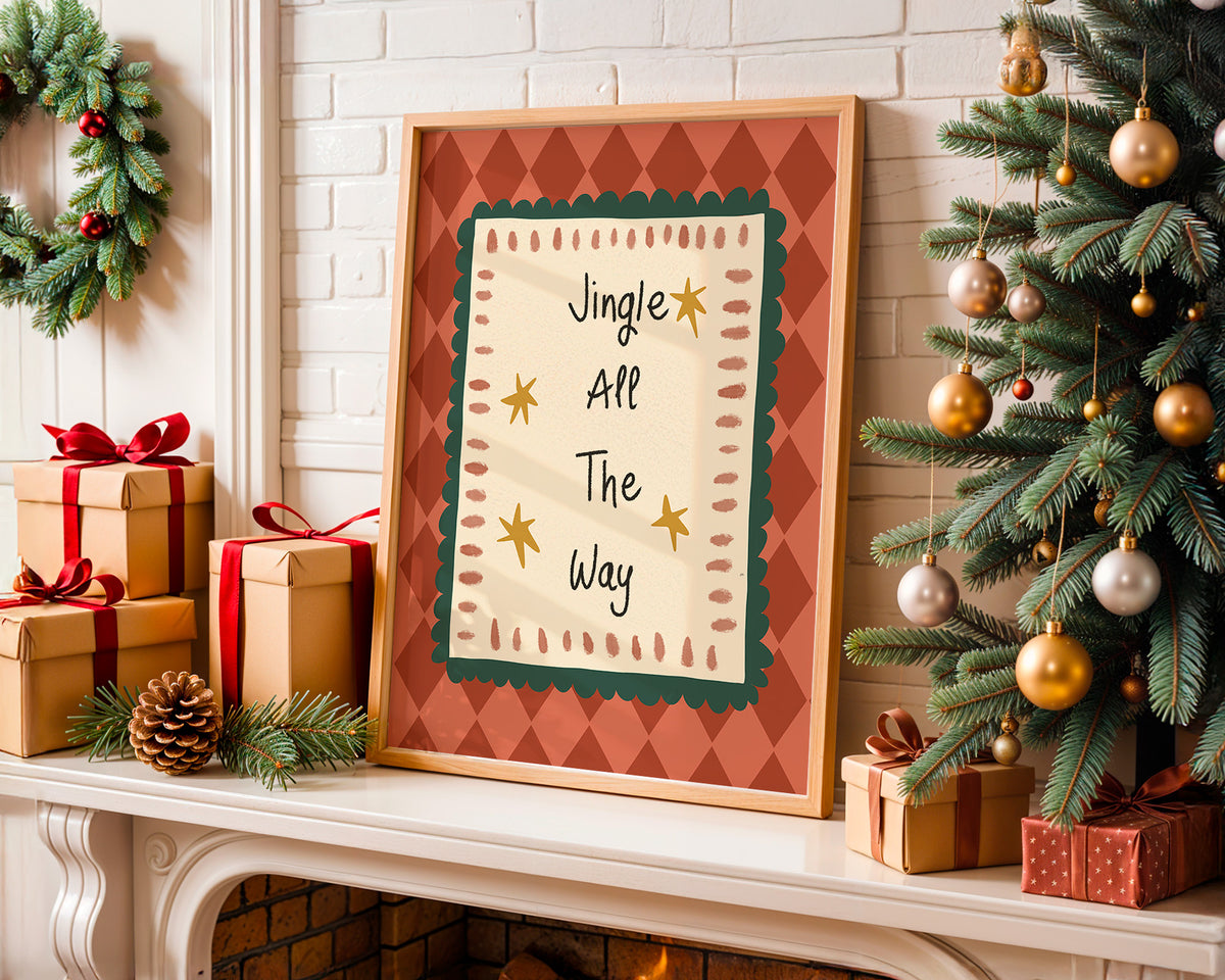 Framed Christmas wall art leaning on a fireplace mantel, surrounded by wrapped gifts, a green wreath, and a decorated Christmas tree. The print reads “Jingle All The Way” with gold stars and a red-and-cream patterned border.