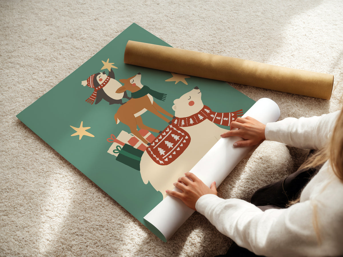 A person unrolls a large sheet of Christmas-themed wrapping paper on a beige carpet, with a rolled gold tube of paper beside it. The sheet features a festive illustration of a polar bear, deer, snowman, and stars in red, brown, white, and teal.